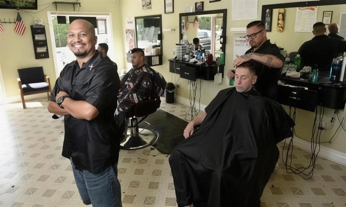 Inside Champ's Barber Shop — Emilio Resendiz on the floor while barbers work with customers